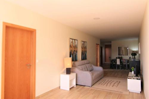a living room with a couch and a table at Elegant House in Calheta, Sea View in Calheta