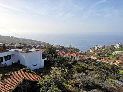a view of a city with the ocean in the background at Elegant House in Calheta, Sea View in Calheta