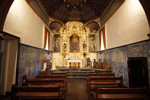 a church with a large altar with wooden pews at Elegant House in Calheta, Sea View in Calheta
