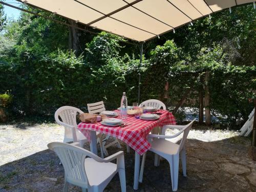 a table with a red and white checkered table cloth at 3 bedrooms villa with private pool enclosed garden and wifi at Osteria delle Noci in Osteria Delle Noci