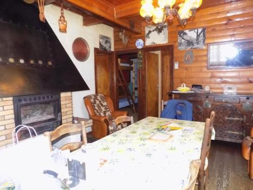 a dining room with a table and a fireplace at Maison de 2 chambres avec vue sur la ville et jardin a Loudenvielle a 5 km des pistes in Loudenvielle