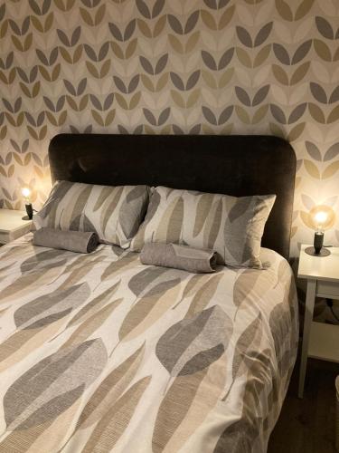 a bed with two pillows on it in a bedroom at Chapel Court Apartments in Cannock
