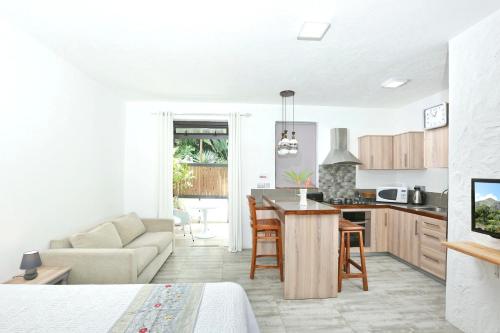 a kitchen and living room with a couch and a table at Studio with city view furnished terrace and wifi at Moka in Moka