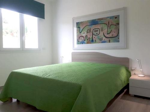 a bedroom with a green bed and two windows at Spacious villa with sea and mountain views in Alcamo in Alcamo