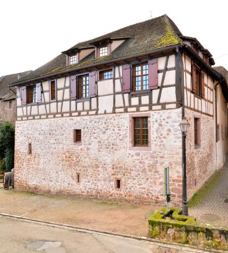 an old stone building with a street light in front of it at My Riquewihr in Riquewihr