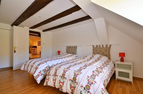 a bedroom with a bed with a colorful bedspread at My Riquewihr in Riquewihr