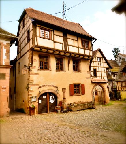 an old building on a cobblestone street at My Riquewihr in Riquewihr