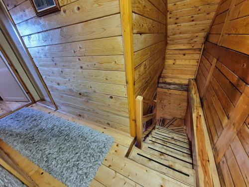 an overhead view of a wooden sauna with a blue rug at Vila Dizdarevic Kopaonik in Kopaonik