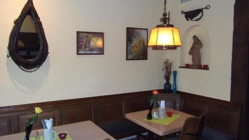 a dining room with two tables and a mirror at Gasthof Stadtschänke in Großbottwar