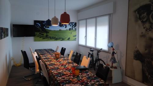 a dining room with a long table with chairs at Garage con camere in Pieve di Soligo
