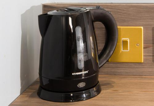 a black coffee pot sitting on a table at Eden Plaza Kensington in London