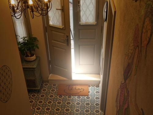 a door with the word luck written on the floor in front of it at Tilas - Rooms in 19th Century Wooden Townhouse,Kadikoy in Istanbul