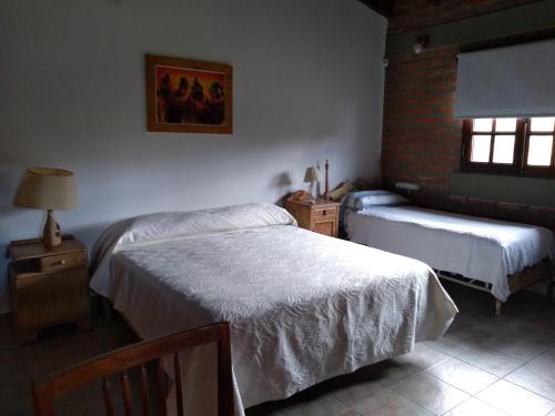 a bedroom with two twin beds and a window at El Indalo La Calderilla in Salta