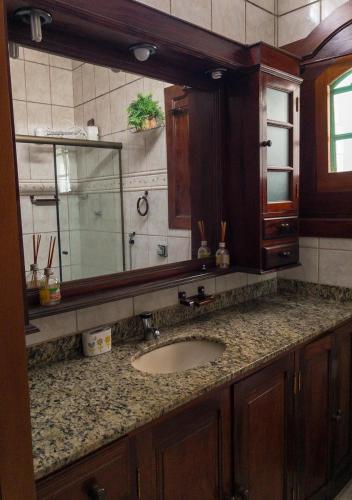 a bathroom with a sink and a mirror at Casarão Paraty in Paraty