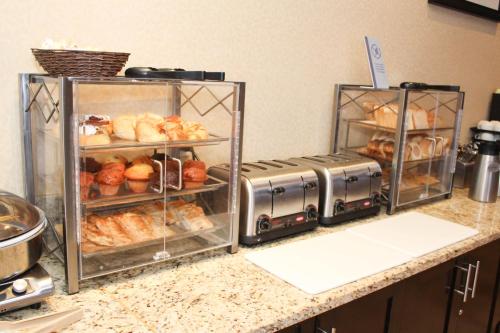 two trays of bread and pastries on a counter at Best Western Sunrise Inn & Suites in Stony Plain