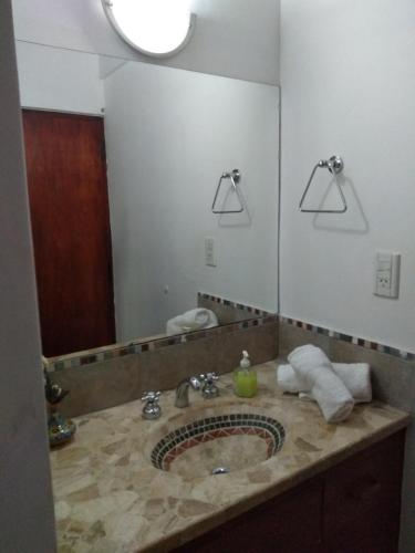 a bathroom with a sink and a large mirror at El Indalo La Calderilla in La Caldera