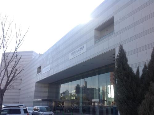 a building with cars parked in front of it at Hiroshima City Bunka Koryu Kaikan in Hiroshima