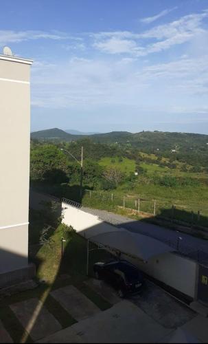 a car parked under a bridge next to a building at Residencial savassi in Betim