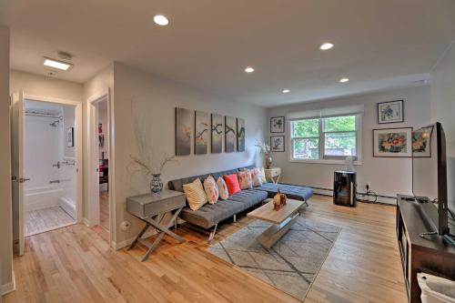 a living room with a couch and a table at Yonkers Apt with Balcony Walk to Train Station! in Yonkers