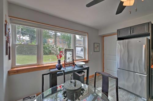 a kitchen with a glass table and a refrigerator at Yonkers Apt with Balcony Walk to Train Station! in Yonkers