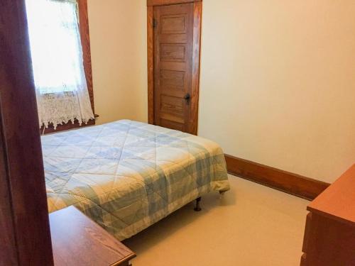 a small bedroom with a bed and a window at Aunt Jane's Two in Put-in-Bay