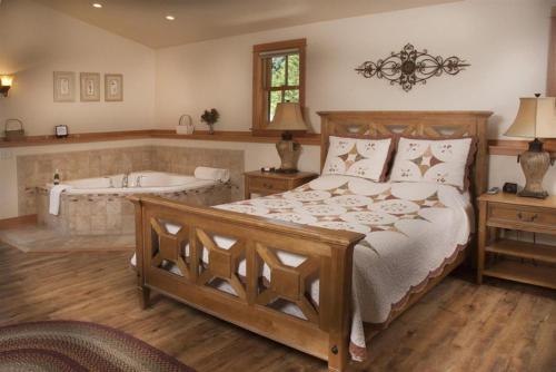a bedroom with a bed and a bath tub at Lake Orchard Farm Retreat in Sheboygan