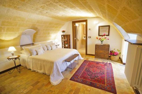 a bedroom with a large bed and a staircase at Malandrì B&B in Altamura