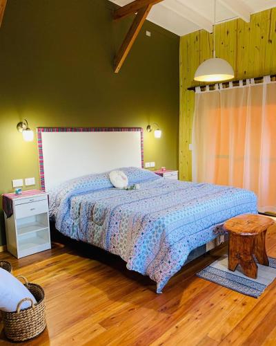 a bedroom with a large bed and a table at Cabañas Namaskar in Villa Serranita