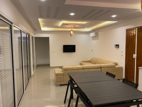 a living room with a couch and a table at VILLA en U PISCINE SANS AUCUN VIS A VIS in Temlale