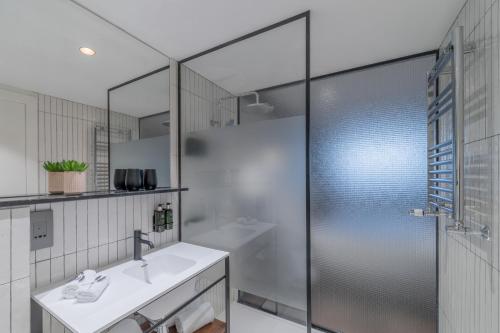 a bathroom with a shower and a sink at Melia White House Hotel in London