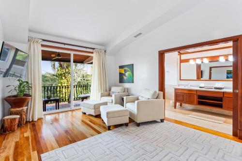 a living room with white furniture and a large window at San Ignacio Resort Hotel in San Ignacio