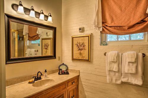 a bathroom with a sink and a mirror at Historic Baton Rouge Vacation Rental 6 Mi to LSU! in Baton Rouge