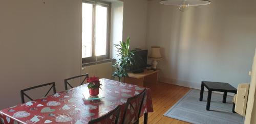 a dining room with a table with a red table cloth at Petit week end dans la vallée in Breitenbach-Haut-Rhin