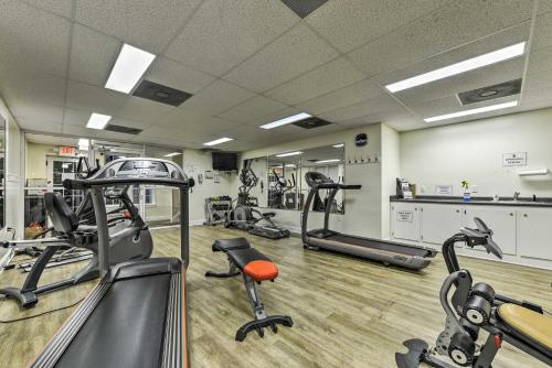 a gym with several treadmills and exercise bikes at Resort-Style CondoandSuite on Golf Course with Pool! in Spring Lake
