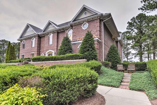 a large brick house with bushes in front of it at Resort-Style CondoandSuite on Golf Course with Pool! in Spring Lake