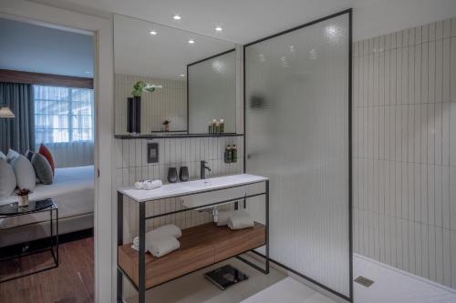 a bathroom with a sink and a shower at Melia White House Hotel in London