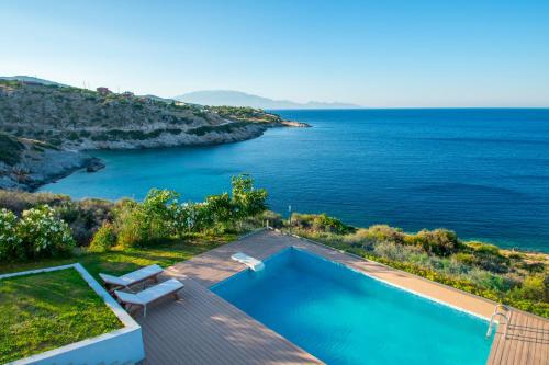 a swimming pool with a view of the ocean at Villa Thalassa - Deja Vu Villas in Agios Nikolaos