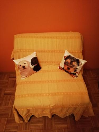 two dogs on pillows on a bed at Studio apartment Meli in Ogulin