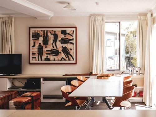 a living room with a table and chairs at Steamboat 2 bedroom with mountain view and central location in Thredbo