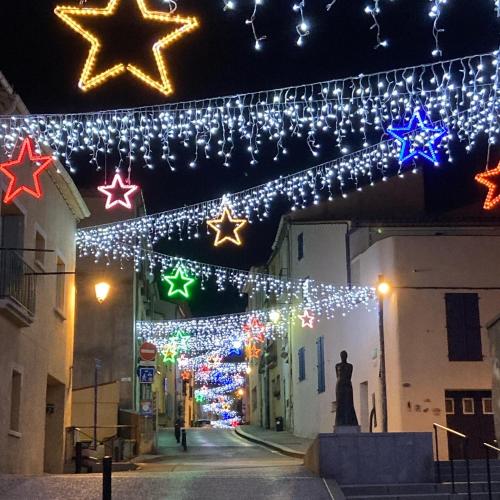 a street with christmas lights hanging from a building at Studio moderne Argeles sur mer.La plage à pieds, Espagne à 30mn in Argelès-sur-Mer