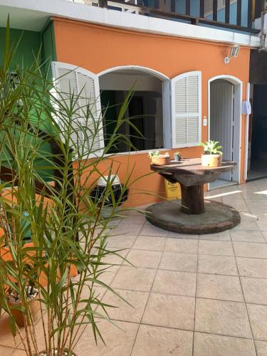 a patio with a table in front of a building at Nova Aldeia Buzios in Búzios