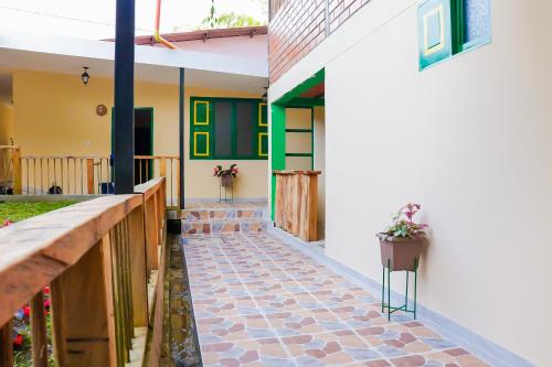 a house with a stone walkway leading to the front yard at Refugio El Abuelo in Santa Rosa de Cabal