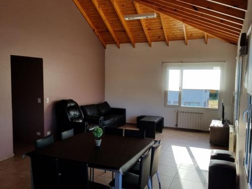 a living room with a table and a couch at DEPARTAMENTO CALAFATE CENTRICO #3 in El Calafate