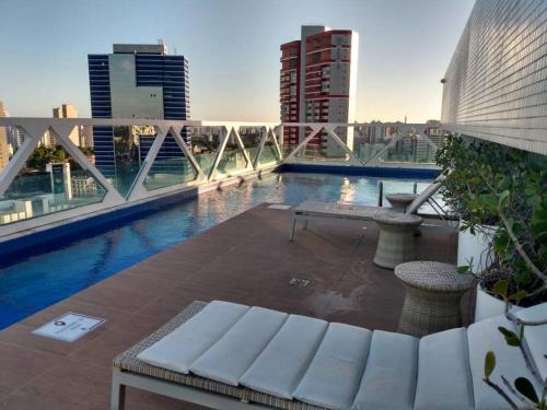 a view of a pool on top of a building at Salvador Business & Flat propriedade in Salvador