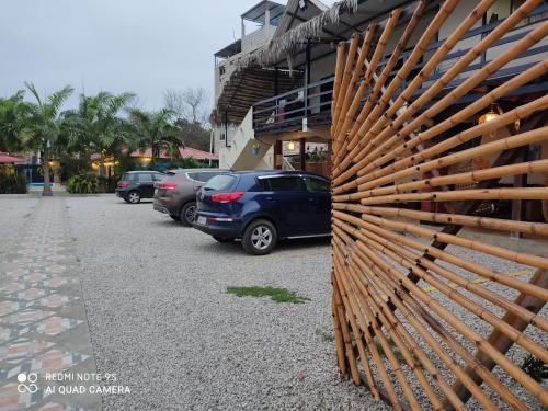 a wooden fence on the side of a parking lot at Hotel Berlín International in Puerto López