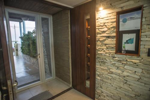 an entrance to a room with a stone wall at Amares Apart - Departamentos 1 y 2 in Santa Clara del Mar