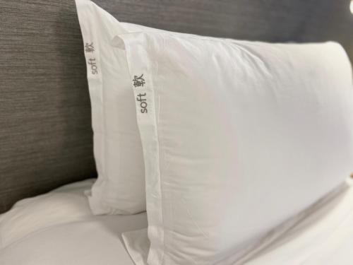 a white pillow sitting on top of a bed at Holiday Inn Express Hong Kong Causeway Bay by IHG in Hong Kong