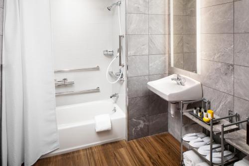 a bathroom with a sink, toilet and bathtub at Saranac Waterfront Lodge in Saranac Lake