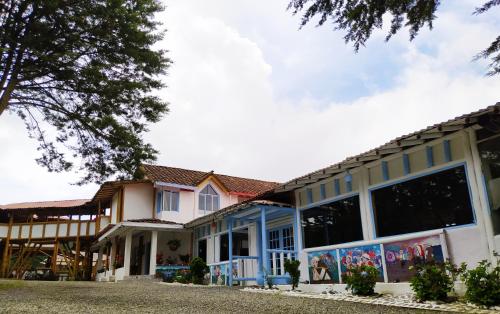 a building with blue and white trim at Eco Hotel Terrabella in Santa Elena