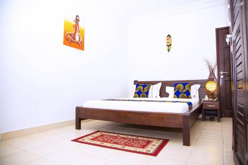 a bedroom with a bed in a room at Cypa Hotel in Abidjan